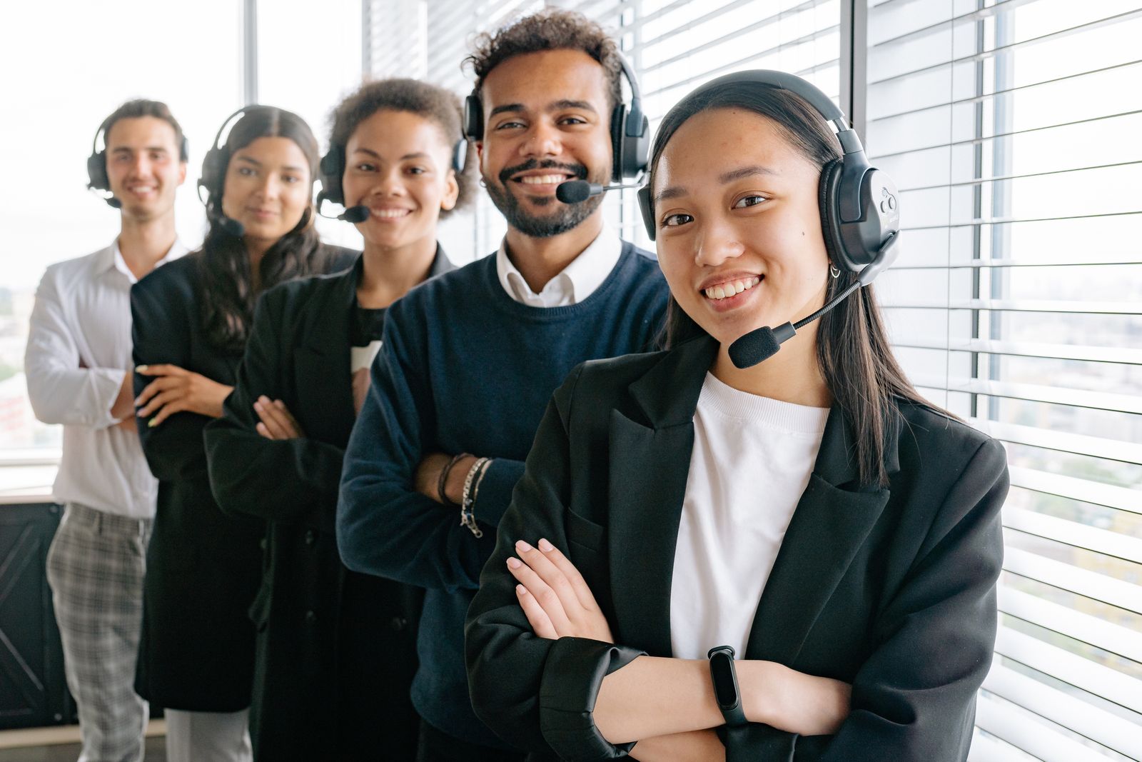 Customer support professionals wearing headsets in a modern office