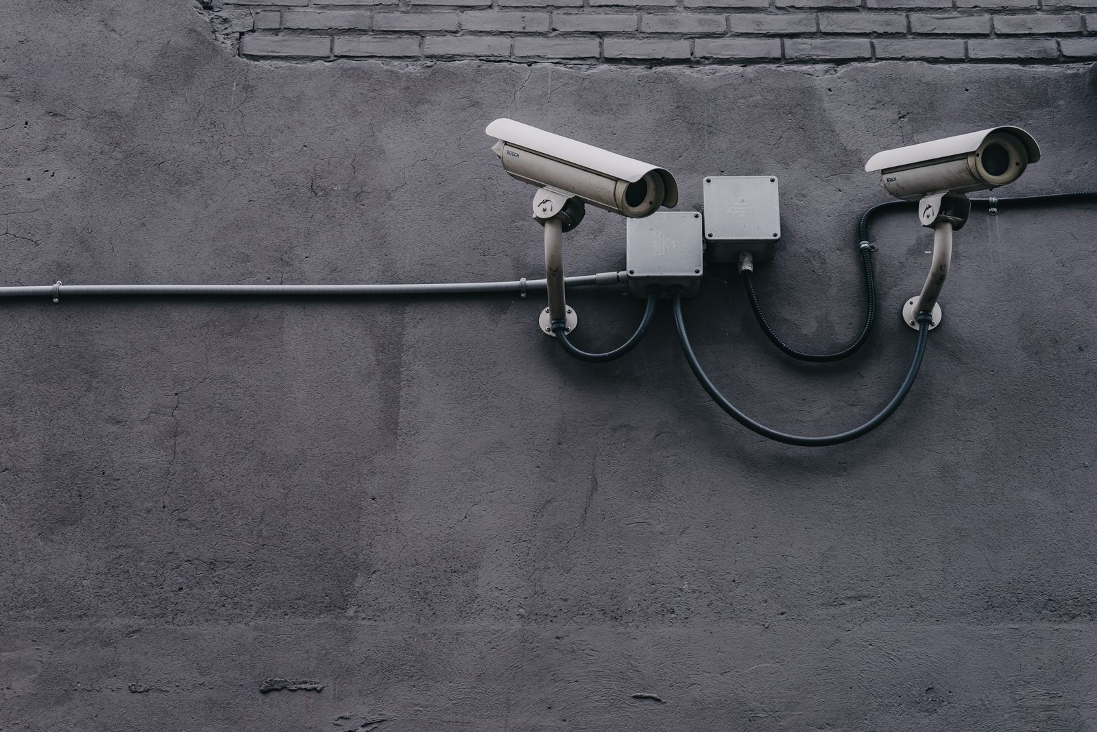 Professional outdoor security cameras mounted on a commercial building wall