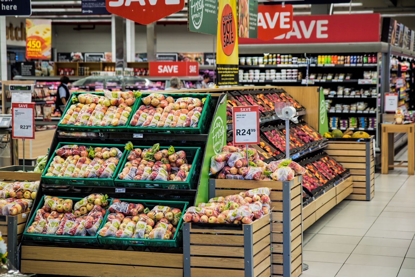 Well-stocked retail grocery produce displays representing inventory-intensive retail