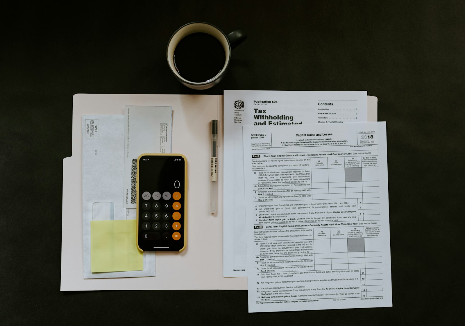 Financial documents and a calculator laid out for reconciliation
